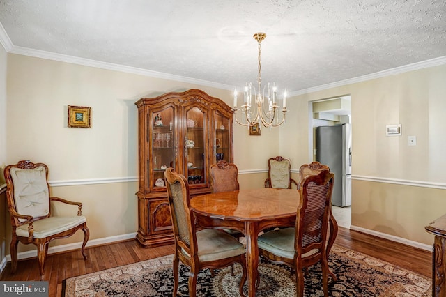 20304 Watkins Meadow Dr, Germantown, MD 20876 - dining room with a chandelier, hardwood / wood-style floors, ornamental molding, and a textured ceiling