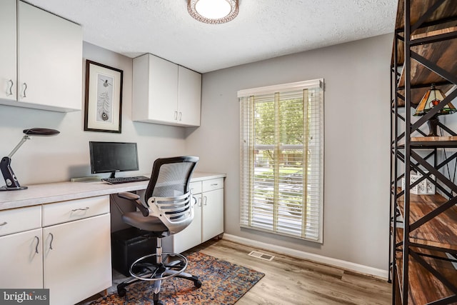 20304 Watkins Meadow Dr, Germantown, MD 20876 - office with light wood-style floors and a textured ceiling