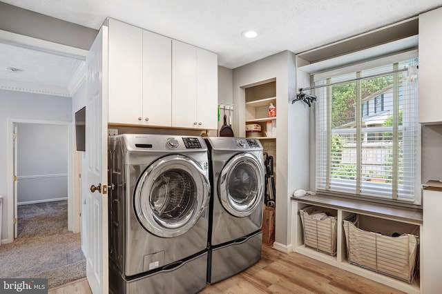 20304 Watkins Meadow Dr, Germantown, MD 20876 - laundry room with cabinet space, independent washer and dryer, light wood-type flooring, crown molding, and recessed lighting