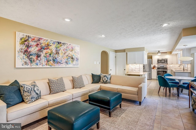 20304 Watkins Meadow Dr, Germantown, MD 20876 - living area with a textured ceiling, arched walkways, light tile patterned flooring, recessed lighting, and ceiling fan
