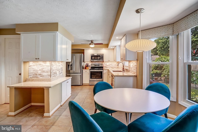 20304 Watkins Meadow Dr, Germantown, MD 20876 - kitchen with stainless steel appliances, light tile patterned floors, tasteful backsplash, and white cabinets