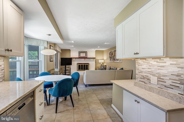 20304 Watkins Meadow Dr, Germantown, MD 20876 - kitchen featuring dishwasher, decorative backsplash, white cabinetry, light tile patterned floors, and light stone counters