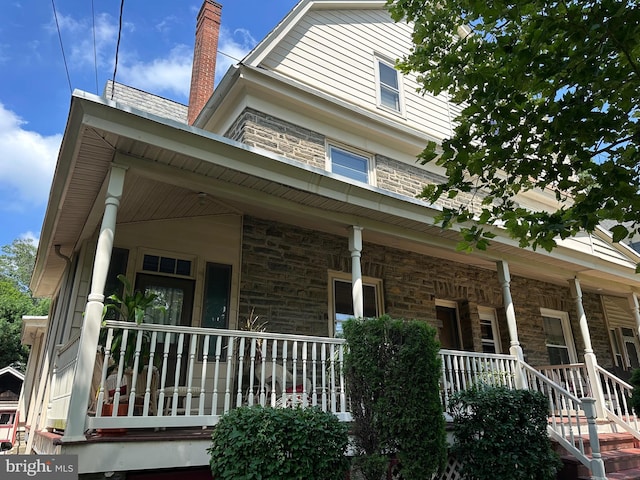116 Township Line Rd, Jenkintown, PA 19046 - view of front of home featuring a porch, stone siding, and a chimney