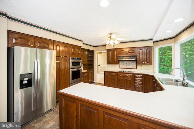 5599 Small Oak Ct, Woodbridge, VA 22192 - kitchen featuring stainless steel appliances, light countertops, a peninsula, a ceiling fan, and under cabinet range hood