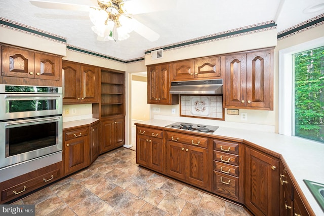 5599 Small Oak Ct, Woodbridge, VA 22192 - kitchen with under cabinet range hood, stovetop, double oven, light countertops, and a ceiling fan