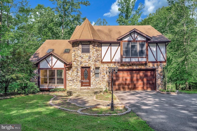 5599 Small Oak Ct, Woodbridge, VA 22192 - tudor house featuring stone siding, an attached garage, asphalt driveway, stucco siding, and a front lawn