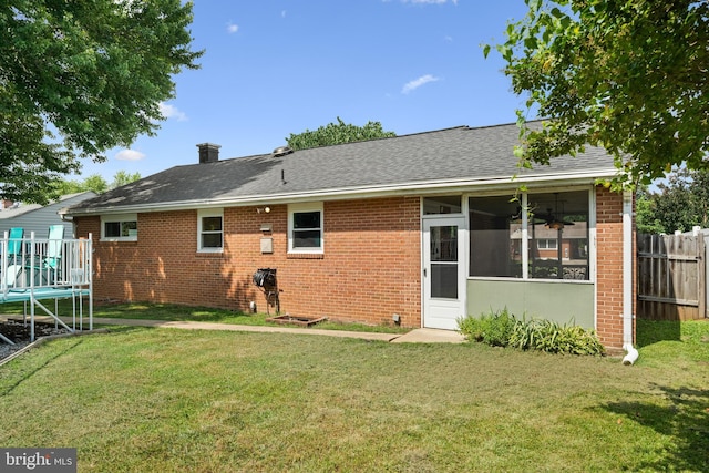 6402 Virginia Hills Ave, Alexandria, VA 22310 - rear view of property with brick siding, a sunroom, a trampoline, and a shingled roof