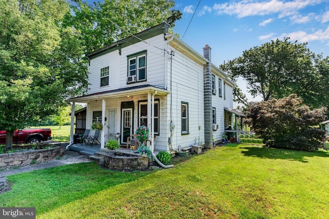 121 Spruce St, Carlisle, PA 17013 - view of front of house with covered porch, a chimney, and a front lawn