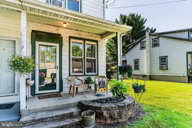 121 Spruce St, Carlisle, PA 17013 - doorway to property featuring a lawn, a porch, and cooling unit