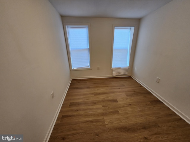 1703 Baker St, Baltimore, MD 21217 - spare room featuring baseboards and dark wood-style flooring