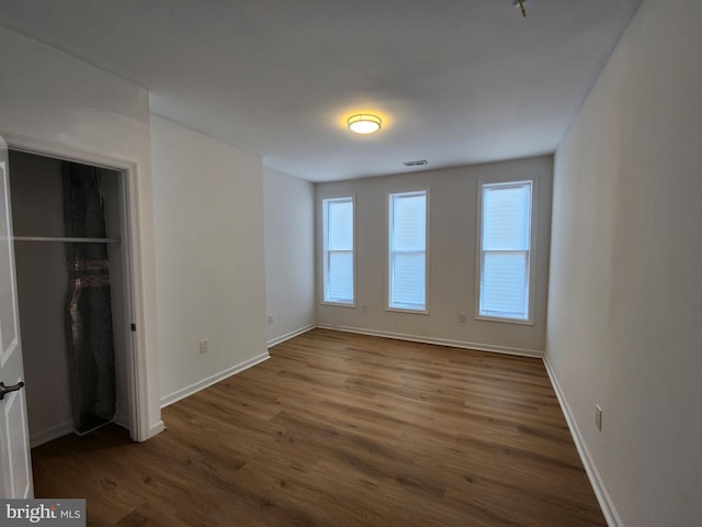 1703 Baker St, Baltimore, MD 21217 - unfurnished bedroom featuring dark wood-style flooring and a closet