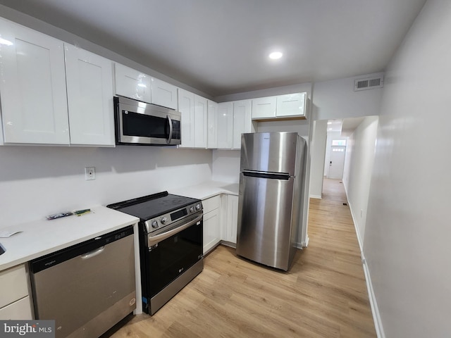 1703 Baker St, Baltimore, MD 21217 - kitchen with stainless steel appliances, white cabinetry, light countertops, and recessed lighting