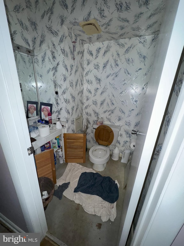 6309 Red Cedar Pl Unit 104, Baltimore, MD 21209 - half bathroom featuring vanity and wallpapered walls