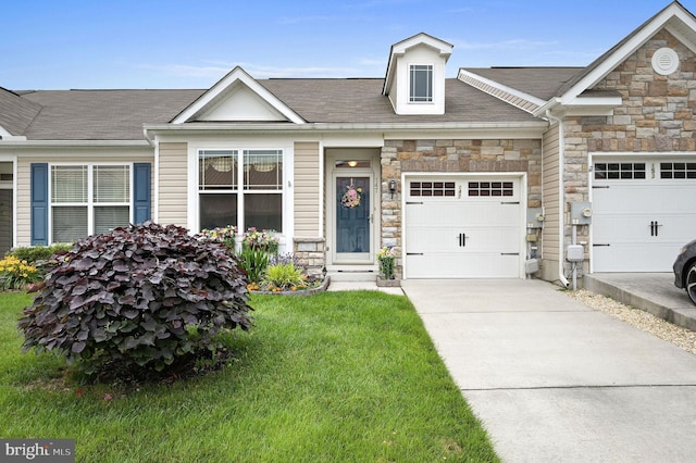 147 Candor Ln, Dover, DE 19901 - multi unit property with stone siding, a garage, concrete driveway, a front yard, and a shingled roof