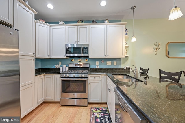 147 Candor Ln, Dover, DE 19901 - kitchen featuring appliances with stainless steel finishes, light wood-style floors, pendant lighting, recessed lighting, and dark stone countertops