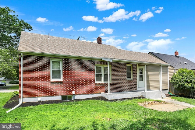522 E Simpson St, Mechanicsburg, PA 17055 - back of property featuring roof with shingles, a yard, brick siding, and a chimney