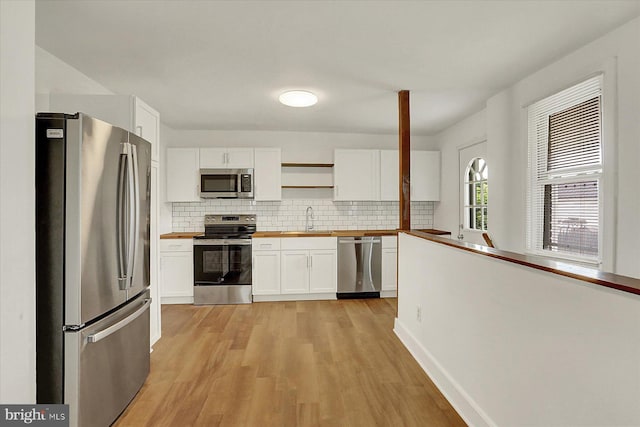 522 E Simpson St, Mechanicsburg, PA 17055 - kitchen with stainless steel appliances, butcher block counters, open shelves, light wood-style flooring, and white cabinets