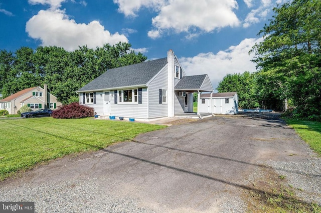 416 Colebrookdale Rd, Boyertown, PA 19512 - view of front facade featuring a storage shed, driveway, a chimney, a shingled roof, and a front lawn
