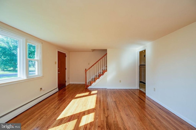 416 Colebrookdale Rd, Boyertown, PA 19512 - unfurnished living room featuring a baseboard heating unit, wood finished floors, and stairway