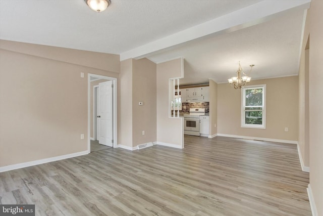 4953 Lincolnwood Dr, York, PA 17408 - unfurnished living room featuring a chandelier and light wood-style flooring
