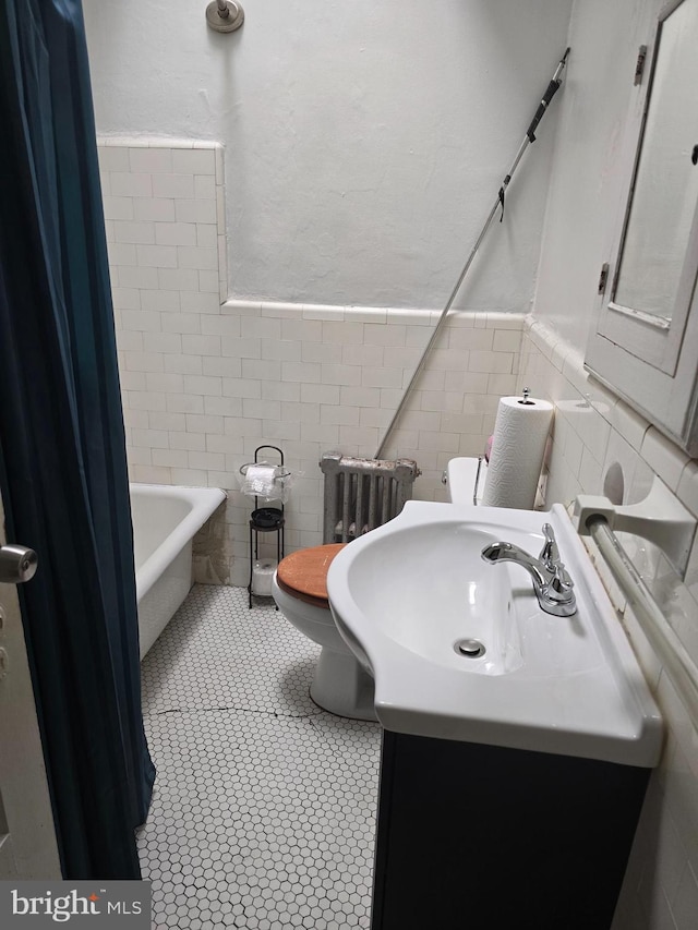 306 E Queen Ln, Philadelphia, PA 19144 - full bathroom with tile walls, radiator heating unit, vanity, a wainscoted wall, and tile patterned flooring