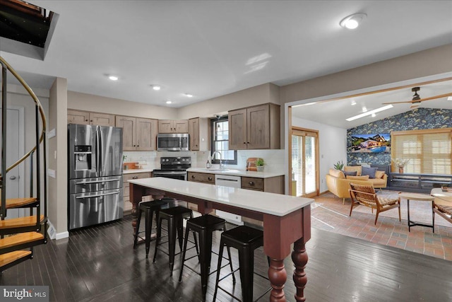 208 Queens Gate Rd, Lititz, PA 17543 - kitchen featuring appliances with stainless steel finishes, light countertops, a breakfast bar, open floor plan, and backsplash