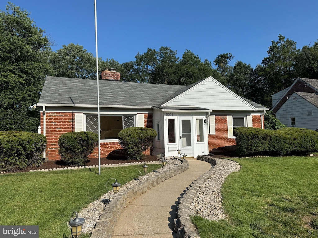 10021 Dallas Ave, Silver Spring, MD 20901 - view of front facade with brick siding, a chimney, a front lawn, and a shingled roof