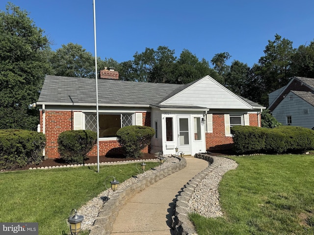 10021 Dallas Ave, Silver Spring, MD 20901 - view of front facade with brick siding, a chimney, a front lawn, and a shingled roof