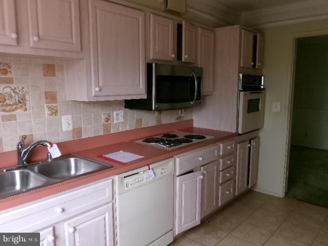 5904 Mount Eagle Dr Unit 210, Alexandria, VA 22303 - kitchen with white appliances, light tile patterned flooring, backsplash, light countertops, and ornamental molding