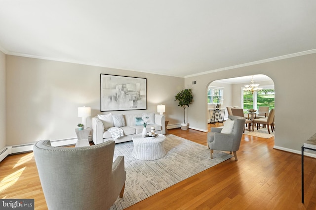 508 Vierling Dr, Silver Spring, MD 20904 - living area with arched walkways, a chandelier, crown molding, light wood finished floors, and a baseboard radiator