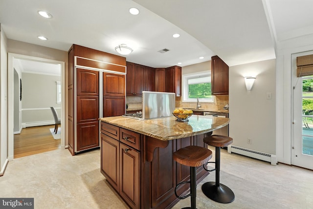 508 Vierling Dr, Silver Spring, MD 20904 - kitchen featuring baseboard heating, a breakfast bar area, a center island, decorative backsplash, and a baseboard radiator