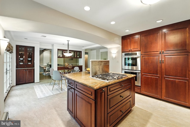 508 Vierling Dr, Silver Spring, MD 20904 - kitchen featuring appliances with stainless steel finishes, arched walkways, light stone countertops, a center island, and pendant lighting