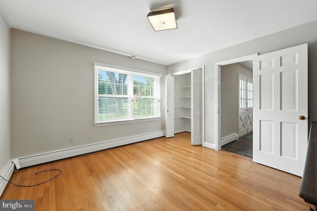 508 Vierling Dr, Silver Spring, MD 20904 - unfurnished bedroom featuring baseboard heating, wood finished floors, and a closet