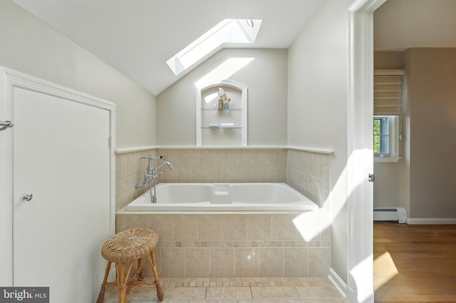 508 Vierling Dr, Silver Spring, MD 20904 - bathroom featuring a skylight, a baseboard radiator, a garden tub, vaulted ceiling, and wood finished floors