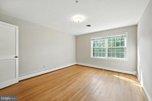 508 Vierling Dr, Silver Spring, MD 20904 - empty room with wood finished floors, a baseboard heating unit, and a baseboard radiator