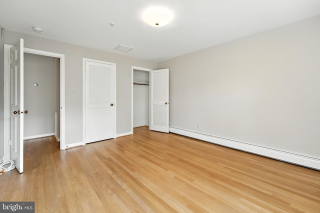 508 Vierling Dr, Silver Spring, MD 20904 - unfurnished bedroom with a baseboard heating unit, light wood-style flooring, and a closet