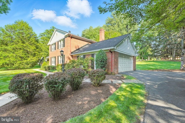 508 Vierling Dr, Silver Spring, MD 20904 - view of front of home with brick siding, a front yard, driveway, a chimney, and a garage