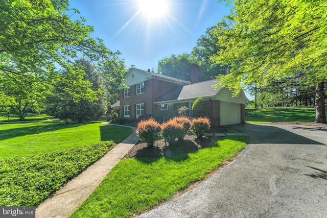 508 Vierling Dr, Silver Spring, MD 20904 - view of front of property with a garage, a front lawn, a chimney, and brick siding