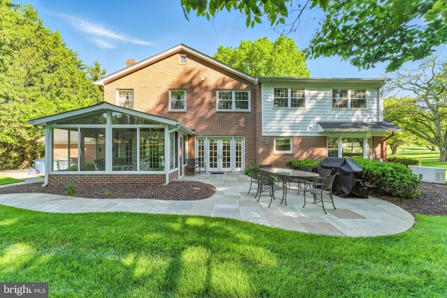 508 Vierling Dr, Silver Spring, MD 20904 - back of house with french doors, a sunroom, a patio, brick siding, and a lawn