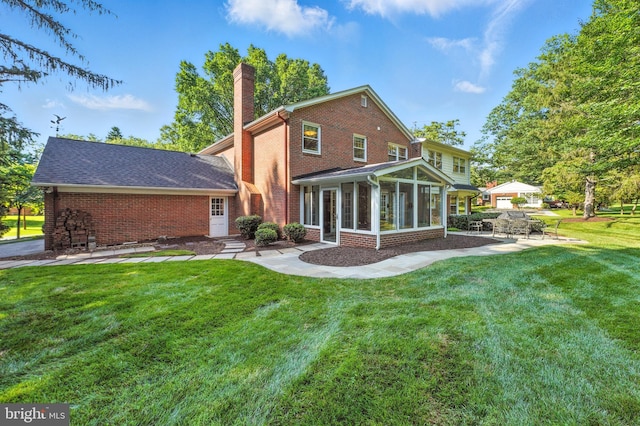 508 Vierling Dr, Silver Spring, MD 20904 - rear view of property with a chimney, brick siding, a sunroom, a patio, and a yard