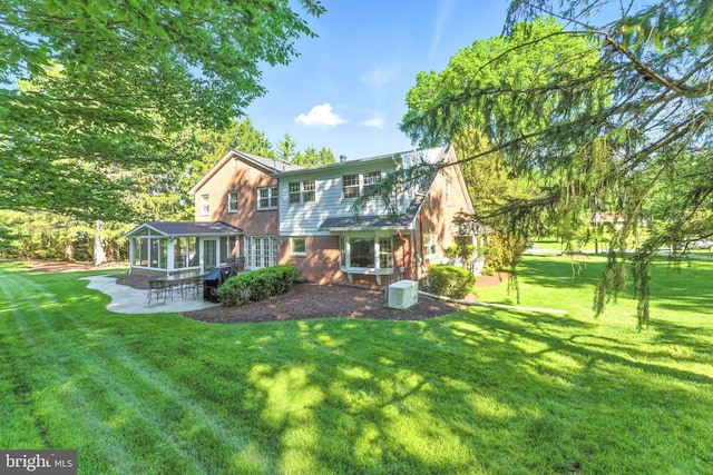 508 Vierling Dr, Silver Spring, MD 20904 - rear view of property with a sunroom, a lawn, a patio area, and brick siding