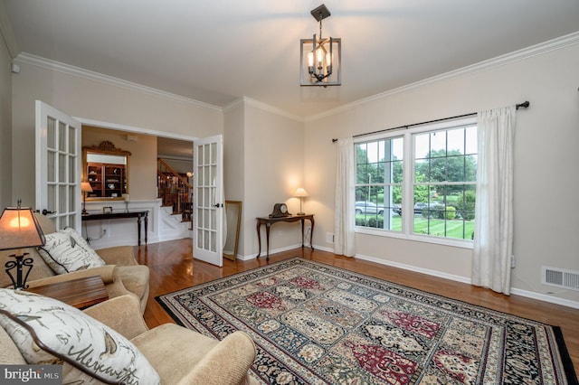 12 Deerpath Ln, Columbus, NJ 08022 - living room featuring wood finished floors, crown molding, stairs, a chandelier, and french doors