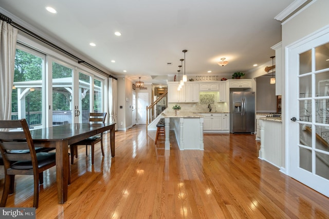 12 Deerpath Ln, Columbus, NJ 08022 - kitchen with stainless steel fridge, white cabinets, crown molding, a kitchen breakfast bar, and recessed lighting