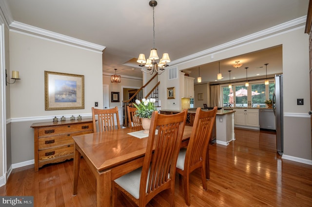 12 Deerpath Ln, Columbus, NJ 08022 - dining area featuring a chandelier, dark wood-type flooring, stairway, and crown molding
