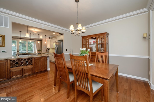 12 Deerpath Ln, Columbus, NJ 08022 - dining space featuring wood finished floors, a chandelier, and ornamental molding