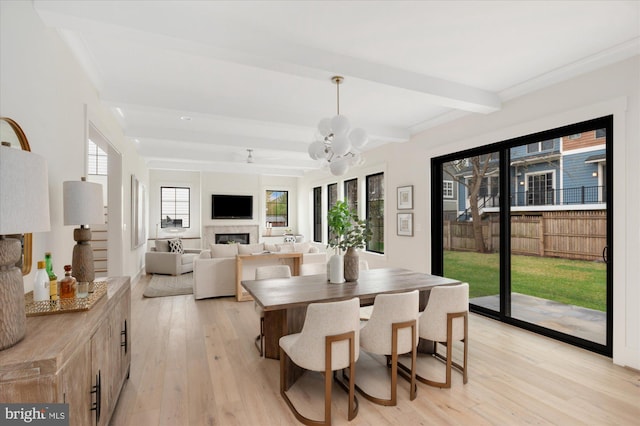 2724 N Dinwiddie St, Arlington, VA 22207 - dining space featuring light wood-style flooring, beamed ceiling, a fireplace, and a chandelier