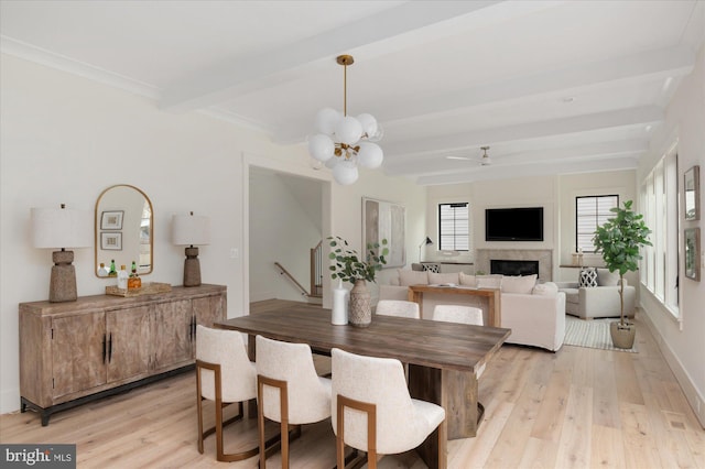 2724 N Dinwiddie St, Arlington, VA 22207 - dining area featuring beam ceiling, light wood-type flooring, a chandelier, a fireplace, and a ceiling fan