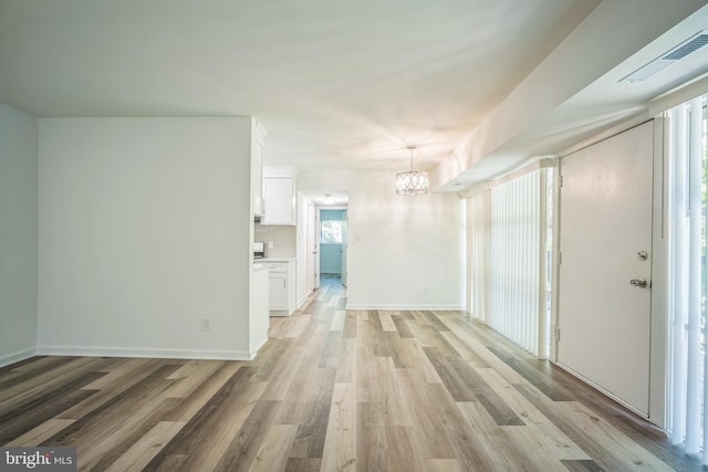 4939 Americana Dr Unit 106, Annandale, VA 22003 - foyer with a chandelier and light wood-style flooring