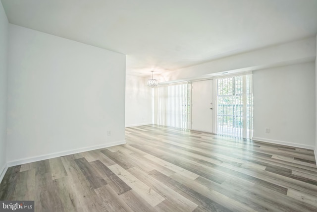 4939 Americana Dr Unit 106, Annandale, VA 22003 - spare room with wood finished floors and a chandelier