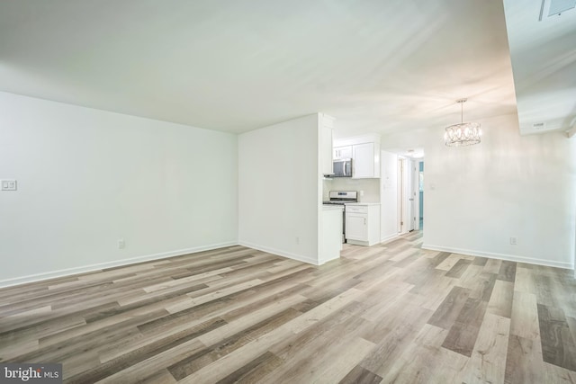 4939 Americana Dr Unit 106, Annandale, VA 22003 - unfurnished living room with a chandelier and light wood-style floors
